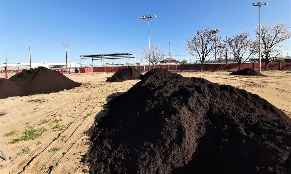 Soil amendments being added to play field